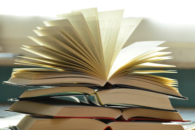 Stack of books with one book open