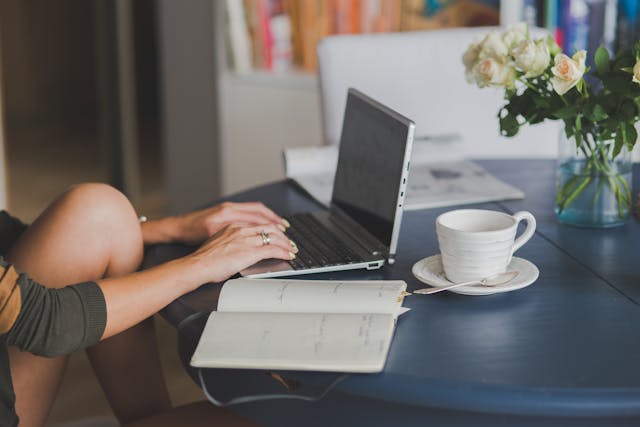 Person typing on a laptop, representing online participation